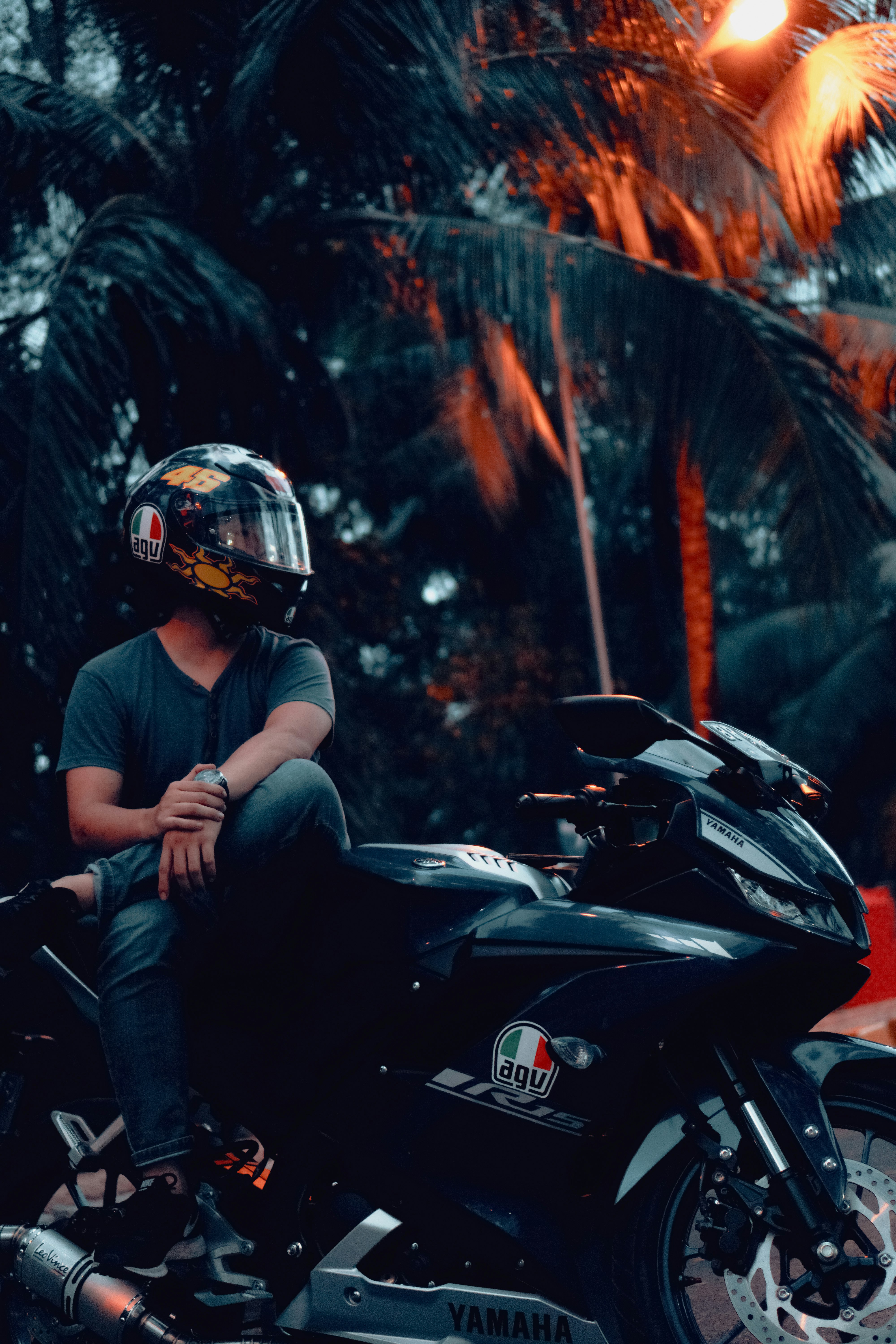 man in blue shirt riding black sports bike